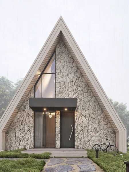 Modern A-frame chalet in Kolašin Montenegro with stone façade and large glass front in the fog